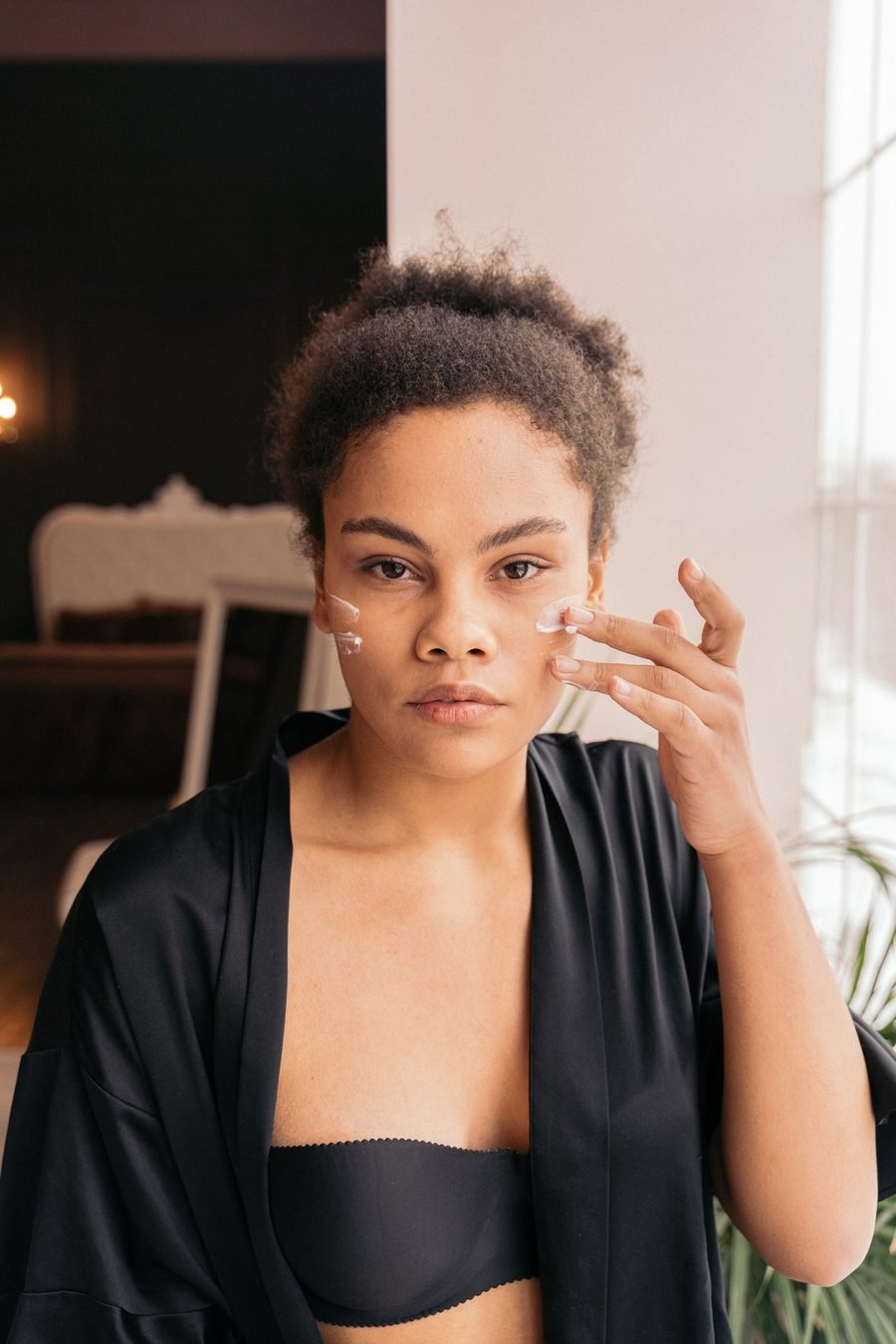 Application d'un soin sur le visage, geste lent et enveloppant